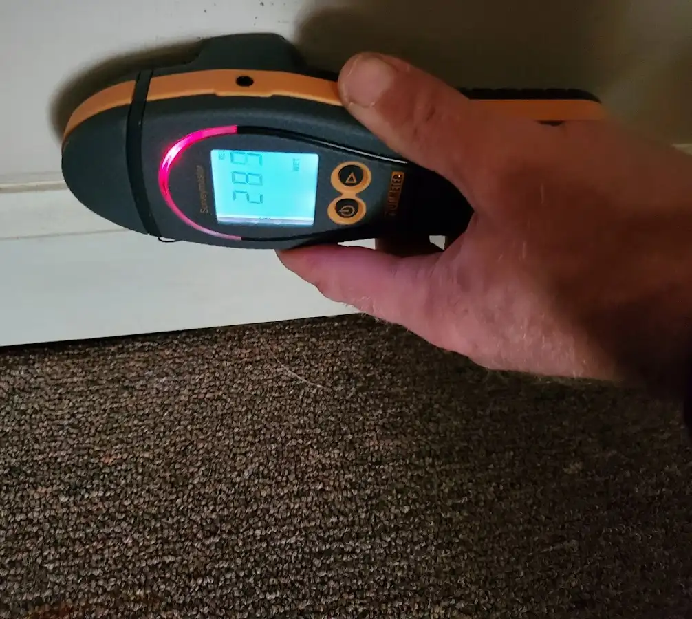 Moisture detection at baseboard during Storm Damage Restoration in Edgerton